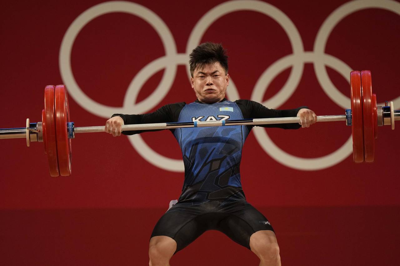 FILE - Igor Son of Kazakhstan competes in the men's 61kg weightlifting event, at the 2020 Summer Ol...