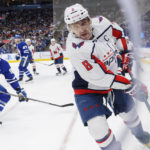 
              Washington Capitals left wing Alex Ovechkin (8) skates a puck out of the corner as Toronto Maple Leafs center John Tavares defends during the third period of an NHL hockey game in Toronto on Sunday, Jan. 29, 2023. (Cole Burston/The Canadian Press via AP)
            
