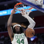 
              Boston Celtics center Robert Williams III (44) dunks during the first half of an NBA basketball game against the Detroit Pistons, Monday, Feb. 6, 2023, in Detroit. (AP Photo/Carlos Osorio)
            