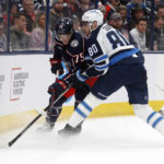 
              Winnipeg Jets forward Pierre-Luc Dubois, right, passes the puck in front of Columbus Blue Jackets defenseman Tim Berni during the first period of an NHL hockey game in Columbus, Ohio, Thursday, Feb. 16, 2023. (AP Photo/Paul Vernon)
            
