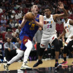 
              Denver Nuggets center Nikola Jokic (15) drives to the basket as Miami Heat center Orlando Robinson (25) defends during the first half of an NBA basketball game, Monday, Feb. 13, 2023, in Miami. (AP Photo/Lynne Sladky)
            
