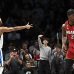 
              Brooklyn Nets forward Mikal Bridges (1) gestures after making a 3-point basket, while Miami Heat forward Jimmy Butler (22) heads to the other end of the court during the first half of an NBA basketball game Wednesday, Feb. 15, 2023, in New York. (AP Photo/Jessie Alcheh)
            