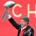 
              FILE - Kansas City Chiefs owner Clark Hunt holds the Super Bowl trophy during a rally in Kansas City, Mo., Wednesday, Feb. 5, 2020. It had been 50 years between Super Bowl trips. The always-pragmatic Hunt uses that stretch in football's wilderness to keep the current ride in the proper perspective. (AP Photo/Orlin Wagner, File)
            