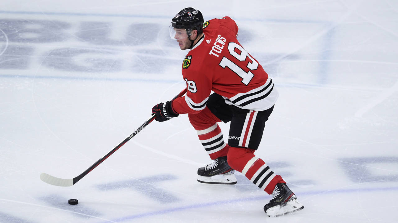 FILE - Chicago Blackhawks' Jonathan Toews (19) moves the puck down ice during the third period of a...