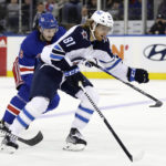 
              Winnipeg Jets left wing Kyle Connor (81) controls the puck past New York Rangers defenseman Jacob Trouba in the second period of an NHL hockey game Monday, Feb. 20, 2023, in New York. (AP Photo/Adam Hunger)
            