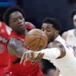 
              Cleveland Cavaliers guard Donovan Mitchell, right, knocks the ball away from Toronto Raptors forward O.G. Anunoby during the first half of an NBA basketball game, Sunday, Feb. 26, 2023, in Cleveland. (AP Photo/Ron Schwane)
            