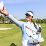 
              Lilia Vu of the USA take selfies with her trophy after winning the LPGA Honda Thailand golf tournament in Pattaya, southern Thailand, Sunday, Feb. 26, 2023. (AP Photo/Kittinun Rodsupan)
            