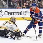 
              Boston Bruins goalie Jeremy Swayman (1) is scored against by Edmonton Oilers' Connor McDavid (97) during second-period NHL hockey game action in Edmonton, Alberta, Monday, Feb. 27, 2023. (Jason Franson/The Canadian Press via AP)
            