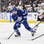 
              Toronto Maple Leafs right wing Mitchell Marner (16) moves the puck during the second period of the team's NHL hockey game against the Chicago Blackhawks on Wednesday, Feb. 15, 2023, in Toronto. (Christopher Katsarov/The Canadian Press via AP)
            
