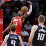 
              Houston Rockets guard Jalen Green (4) dunks in front of Sacramento Kings guard Kevin Huerter (9) and forward Domantas Sabonis (10) during the first half of an NBA basketball game Wednesday, Feb. 8, 2023, in Houston. (AP Photo/Michael Wyke)
            