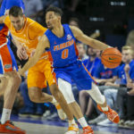 
              Tennessee guard Santiago Vescovi, center, tries to get through Florida forward Colin Castleton, left, and Florida guard Myreon Jones (0) during the first half of an NCAA college basketball game, Wednesday, Feb. 1, 2023, in Gainesville, Fla. (AP Photo/Alan Youngblood)
            