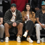 
              Rapper Bad Bunny, second from left, watches during the first half of an NBA basketball game between the Los Angeles Lakers and the Oklahoma City Thunder Tuesday, Feb. 7, 2023, in Los Angeles. (AP Photo/Marcio Jose Sanchez)
            