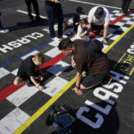 
              Fans sign their name on the finish line ahead of practice sessions before a NASCAR exhibition auto race at Los Angeles Memorial Coliseum, Saturday, Feb. 4, 2023, in Los Angeles. (AP Photo/Ashley Landis)
            