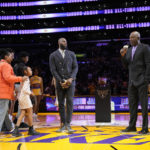 
              Los Angeles Lakers forward LeBron James, center, is introduced by former Laker James Worthy, right, during a ceremony honoring James as the NBA's all-time leading scorer before an NBA game against the Milwaukee Bucks on Thursday, Feb. 9, 2023, in Los Angeles. James passed Kareem Abdul-Jabbar to earn the record during Tuesday's NBA game against the Oklahoma City Thunder. (AP Photo/Mark J. Terrill)
            