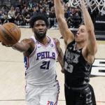 
              Philadelphia 76ers center Joel Embiid (21) drives to the basket against San Antonio Spurs forward Zach Collins (23) during the first half of an NBA basketball game in San Antonio, Friday, Feb. 3, 2023. (AP Photo/Eric Gay)
            
