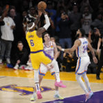 
              Los Angeles Lakers forward LeBron James, left, scores to pass Kareem Abdul-Jabbar to become the NBA's all-time leading scorer as Oklahoma City Thunder guard Josh Giddey, center, and forward Kenrich Williams defend during the second half of an NBA basketball game Tuesday, Feb. 7, 2023, in Los Angeles. (AP Photo/Mark J. Terrill)
            