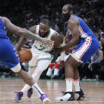 
              Boston Celtics guard Jaylen Brown (7) drives to the basket between Philadelphia 76ers guard James Harden, right, and forward P.J. Tucker (17) during the first half of an NBA basketball game, Wednesday, Feb. 8, 2023, in Boston. (AP Photo/Charles Krupa)
            