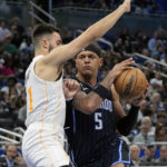 
              Orlando Magic's Paolo Banchero (5) goes to the basket against Miami Heat's Max Strus during the second half of an NBA basketball game, Saturday, Feb. 11, 2023, in Orlando, Fla. (AP Photo/John Raoux)
            