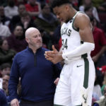 
              Milwaukee Bucks' Giannis Antetokounmpo holds his injured right hand as he and a member of the medical staff head to the locker room during the first half of the team's NBA basketball game against the Chicago Bulls on Thursday, Feb. 16, 2023, in Chicago. (AP Photo/Charles Rex Arbogast)
            