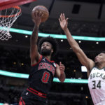 
              Chicago Bulls' Coby White drives to the basket past Milwaukee Bucks' Thanasis Antetokounmpo during the first half of an NBA basketball game Thursday, Feb. 16, 2023, in Chicago. (AP Photo/Charles Rex Arbogast)
            