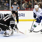 
              New Jersey Devils goaltender Vitek Vanecek (41) deflects a shot by Vancouver Canucks left wing Anthony Beauvillier (72) during the first period of an NHL hockey game Monday, Feb. 6, 2023, in Newark, N.J. (AP Photo/Bill Kostroun)
            
