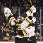 
              Boston Bruins goalie Linus Ullmark, left, celebrates his empty-net goal against the Vancouver Canucks with Brandon Carlo during the third period of an NHL hockey game in Vancouver, British Columbia, Saturday, Feb. 25, 2023. (Rich Lam/The Canadian Press via AP)
            