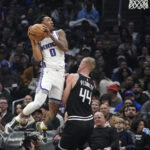 
              Sacramento Kings guard Malik Monk, left, shoots as Los Angeles Clippers center Mason Plumlee defends during the first half of an NBA basketball game Friday, Feb. 24, 2023, in Los Angeles. (AP Photo/Mark J. Terrill)
            
