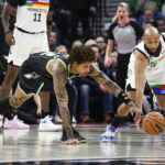 
              Minnesota Timberwolves guard Jordan McLaughlin, right, steals the ball from Charlotte Hornets guard Kelly Oubre Jr. during the first half of an NBA basketball game Friday, Feb. 24, 2023, in Minneapolis. (AP Photo/Craig Lassig)
            