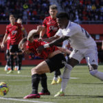 
              Real Madrid's Vinicius Junior, right, challenges for the ball with Mallorca's Pablo Maffeo during a Spanish La Liga soccer match between Mallorca and Real Madrid at the Son Moix stadium in Palma de Mallorca, Spain, Sunday, Feb. 5, 2023. (AP Photo/Francisco Ubilla)
            
