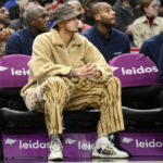 
              Washington Wizards forward Kyle Kuzma watches from the bench in street clothes during the first half of an NBA basketball game against the Cleveland Cavaliers, Monday, Feb. 6, 2023, in Washington. (AP Photo/Nick Wass)
            