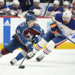 
              Colorado Avalanche center Denis Malgin, left, picks up the puck as Edmonton Oilers center Devin Shore, right, pursues in the second period of an NHL hockey game Sunday, Feb. 19, 2023, in Denver. (AP Photo/David Zalubowski)
            