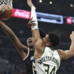 
              Los Angeles Clippers guard Terance Mann (14) shoots as Milwaukee Bucks forward Giannis Antetokounmpo (34) defends during the first half of an NBA basketball game Friday, Feb. 10, 2023, in Los Angeles. (AP Photo/Mark J. Terrill)
            