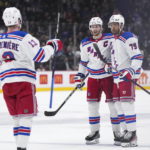 
              New York Rangers' Jacob Trouba (8), K'Andre Miller (79) and Alexis Lafreniere (13) celebrate Miller's goal against the Vancouver Canucks during the second period of an NHL hockey game Wednesday, Feb. 15, 2023, in Vancouver, British Columbia. (Darryl Dyck/The Canadian Press via AP)
            