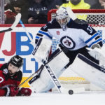 
              Winnipeg Jets goaltender Connor Hellebuyck (37) watches the puck, next to New Jersey Devils' Tomas Tatar (90) during the first period of an NHL hockey game Sunday, Feb. 19, 2023, in Newark, N.J. (AP Photo/Frank Franklin II)
            