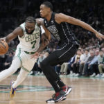 
              Boston Celtics guard Jaylen Brown (7) drives to the basket against Brooklyn Nets center Nic Claxton (33) during the first half of an NBA basketball game, Wednesday, Feb. 1, 2023, in Boston. (AP Photo/Charles Krupa)
            