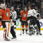 
              Los Angeles Kings goaltender Pheonix Copley, second from right, is held back by referee Ian Walsh, right, after Anaheim Ducks goaltender John Gibson crossed center ice during a fight in the second period of an NHL hockey game Friday, Feb. 17, 2023, in Anaheim, Calif. Copley was tossed from the game with a match penalty. (AP Photo/Mark J. Terrill)
            