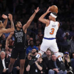
              New York Knicks guard Josh Hart (3) looks to pass against Brooklyn Nets center Nic Claxton (33) and guard Cam Thomas (24) during the first half of an NBA basketball game, Monday, Feb. 13, 2023, in New York. (AP Photo/Jessie Alcheh)
            