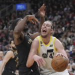 
              Utah Jazz's Kelly Olynyk, right, drives against Toronto Raptors' Precious Achiuwa during the first half of an NBA basketball game Friday, Feb. 10, 2023, in Toronto. (Chris Young/The Canadian Press via AP)
            