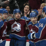 
              Colorado Avalanche center Alex Newhook, second from left, is congratulated after scoring a goal against the Calgary Flames by, from left, right wing Logan O'Connor, center Andrew Cogliano and defenseman Kurtis MacDermid during the first period of an NHL hockey game Saturday, Feb. 25, 2023, in Denver. (AP Photo/David Zalubowski)
            