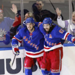 
              New York Rangers center Mika Zibanejad (93) celebrates with defenseman Ryan Lindgren (55) after scoring a goal against the Calgary Flames during the third period of an NHL hockey game, Monday, Feb. 6, 2023, in New York. (AP Photo/Noah K. Murray)
            