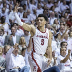 
              Alabama guard Jahvon Quinerly (5) signals a 3-pointer after his shot fell during the second half of an NCAA college basketball game against Arkansas, Saturday, Feb. 25, 2023, in Tuscaloosa, Ala. (AP Photo/Vasha Hunt)
            