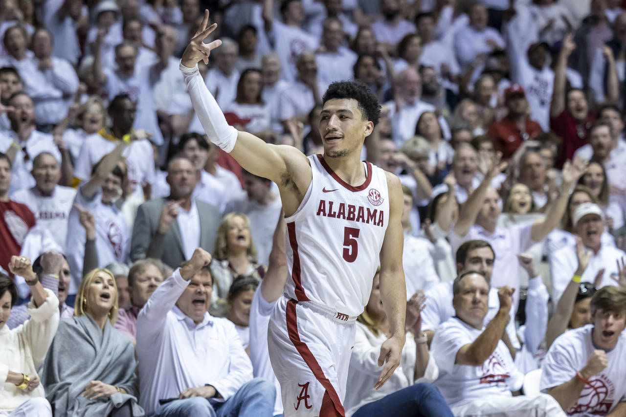 Alabama guard Jahvon Quinerly (5) signals a 3-pointer after his shot fell during the second half of...