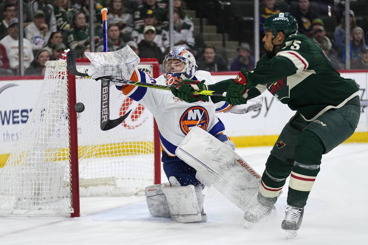 Minnesota Wild right wing Ryan Reaves shoots and scores a goal past New York Islanders goaltender I...