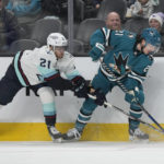 
              San Jose Sharks center Michael Eyssimont, right, reaches for the puck next to Seattle Kraken center Alex Wennberg during the first period of an NHL hockey game in San Jose, Calif., Monday, Feb. 20, 2023. (AP Photo/Jeff Chiu)
            