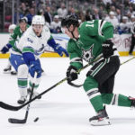
              Dallas Stars center Ty Dellandrea (10) attempts to shoot as Vancouver Canucks' Guillaume Brisebois (55) defends in the first period of an NHL hockey game, Monday, Feb. 27, 2023, in Dallas. (AP Photo/Tony Gutierrez)
            
