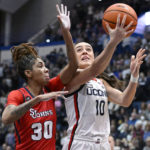 
              UConn's Nika Muhl (10) goes up to the basket as St. John's Kadaja Bailey (30) defends in the first half of an NCAA college basketball game, Tuesday, Feb. 21, 2023, in Hartford, Conn. (AP Photo/Jessica Hill)
            