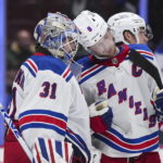 
              New York Rangers goalie Igor Shesterkin, left, and Jacob Trouba celebrate the team's win over the Vancouver Canucks in an NHL hockey game Wednesday, Feb. 15, 2023, in Vancouver, British Columbia. (Darryl Dyck/The Canadian Press via AP
            