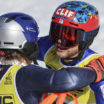 
              Greece's Aj Ginnis, right, hugs Norway's Henrik Kristoffersen after completing the men's World Championship slalom, in Courchevel, France, Sunday Feb. 19, 2023. Ginnis won the silver as Kristoffersen took the gold. (AP Photo/Marco Trovati)
            