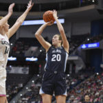
              Villanova's Maddy Siegrist (20) shoots over UConn's Dorka Juhasz (14) in the first half of an NCAA college basketball game, Sunday, Jan. 29, 2023, in Hartford, Conn. (AP Photo/Jessica Hill)
            