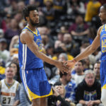 
              Golden State Warriors forward Jonathan Kuminga, right, congratulates forward Andrew Wiggins after his basket in the first half of an NBA basketball game against the Denver Nuggets, Thursday, Feb. 2, 2023, in Denver. (AP Photo/David Zalubowski)
            